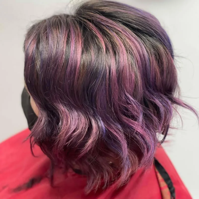 Plum and violet highlights on a wavy bob